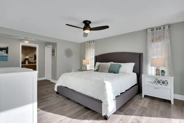 a bedroom with a bed and a chandelier