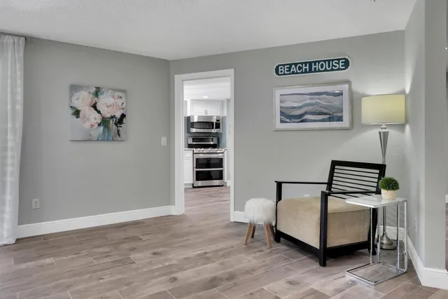 a living room with furniture and a painting on the wall
