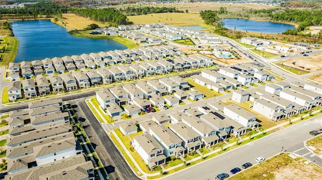 an aerial view of residential houses with outdoor space