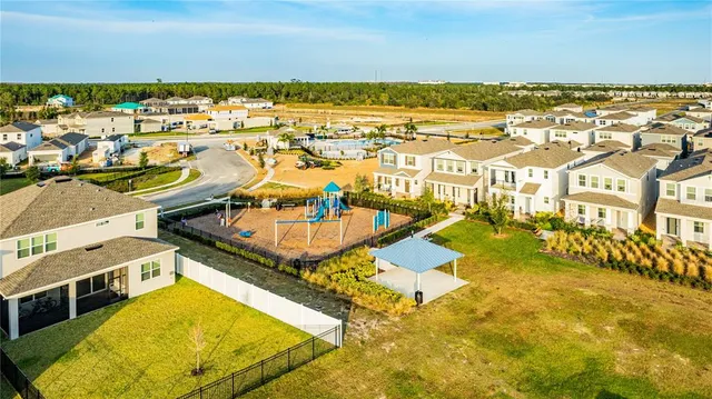 an aerial view of residential houses with outdoor space