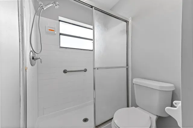 a white toilet sitting next to a bathroom sink