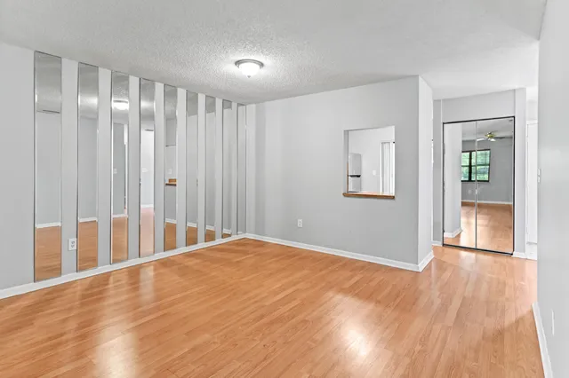 a view of an empty room with wooden floor