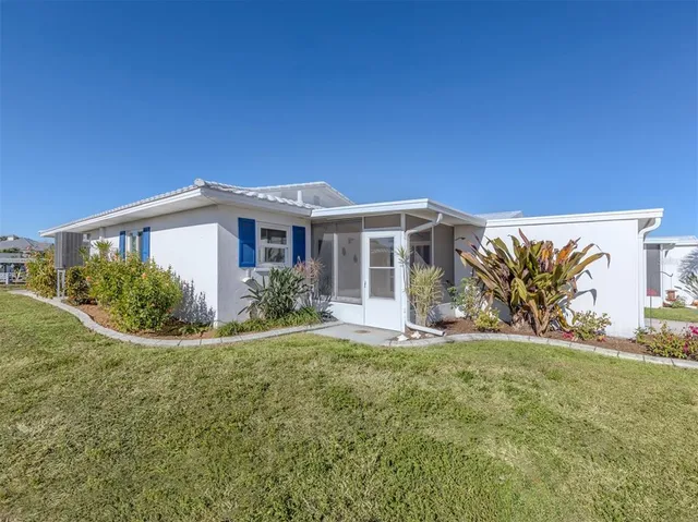 a view of a patio with couches and table and chairs and potted plants