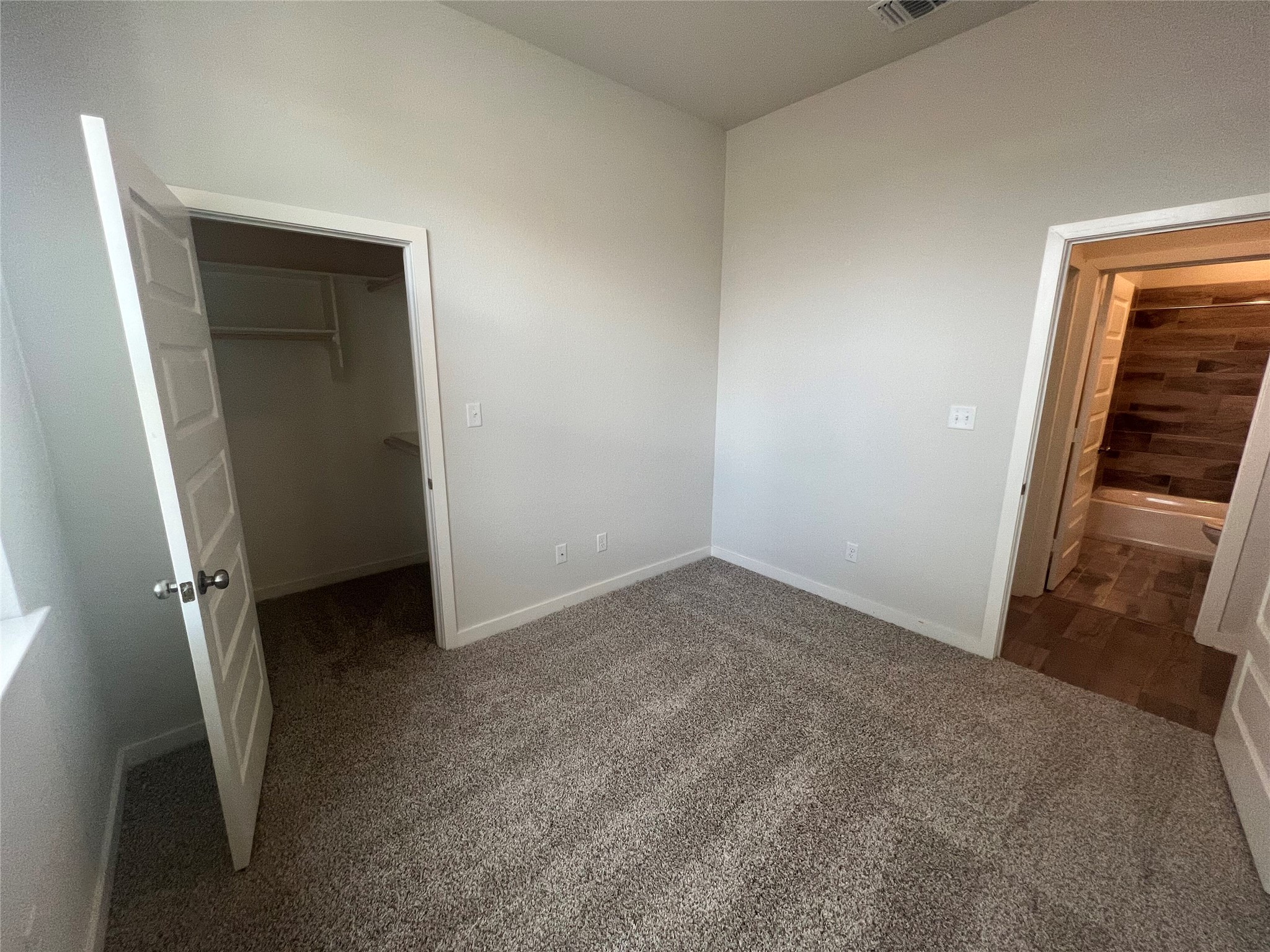 255 Gus Loop Georgetown, TX 78626 - Photo 8 of 24 A well-proportioned room with plush carpeting offers convenient access to a spacious closet and a nearby bathroom.