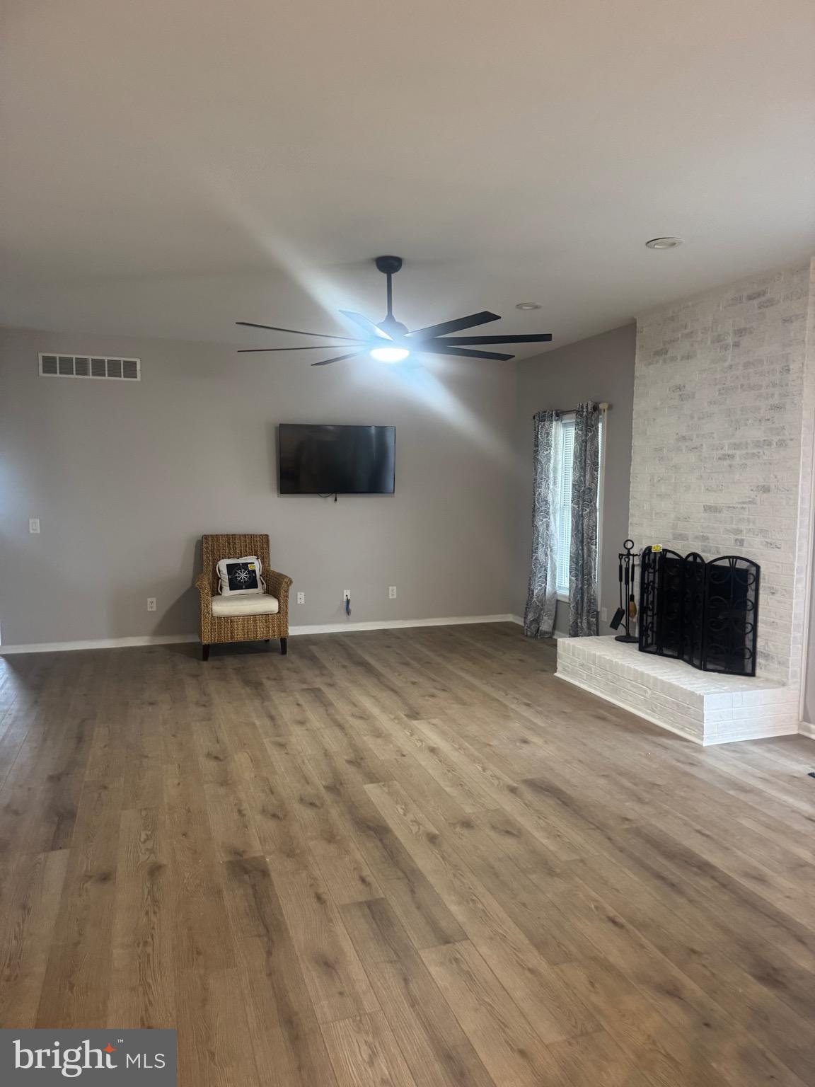 10342 Friendship Road Berlin, MD 21811 - Photo 11 of 35 a view of a livingroom with wooden floor and a flat screen tv