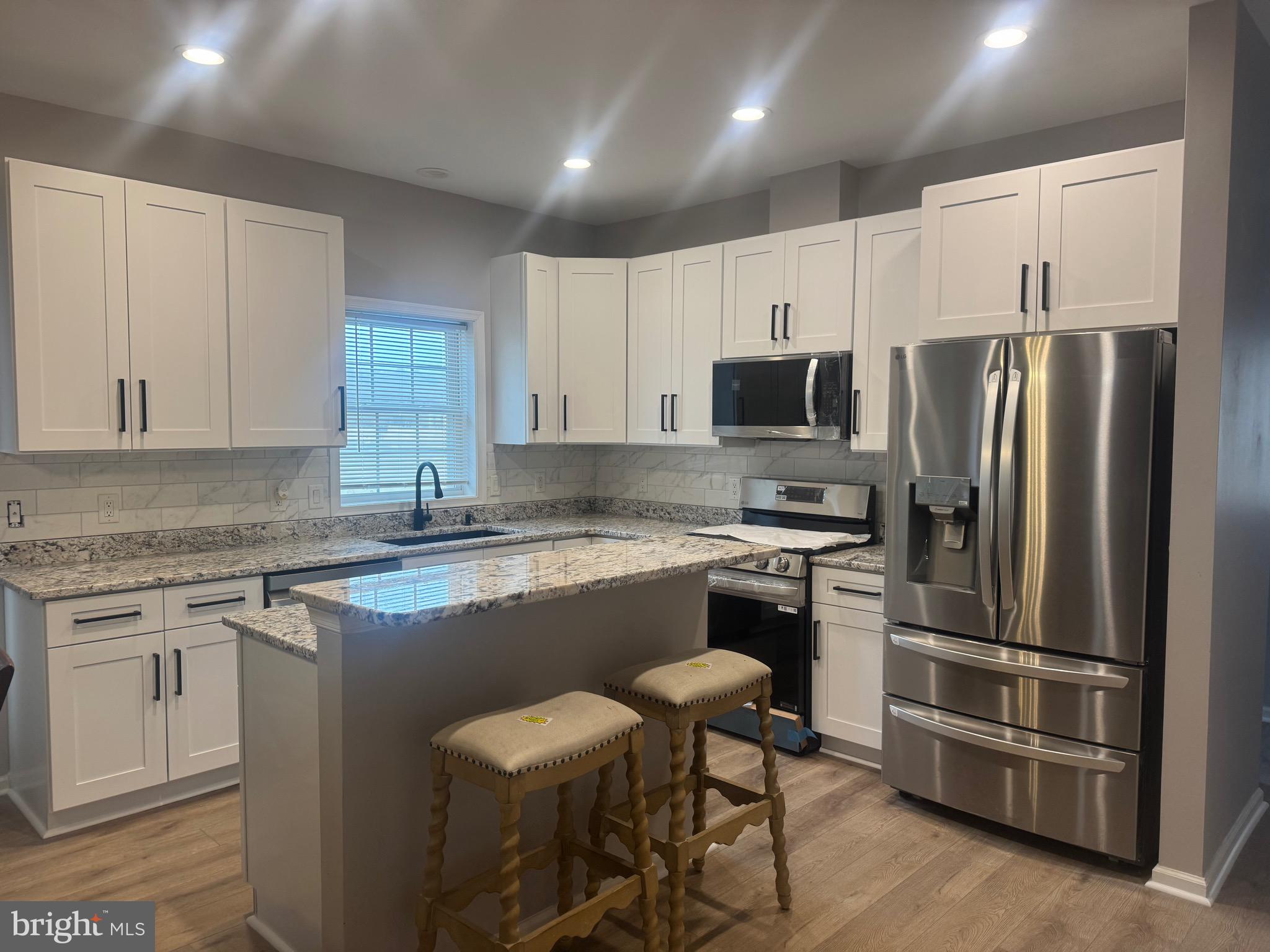 10342 Friendship Road Berlin, MD 21811 - Photo 13 of 28 a kitchen with a refrigerator stove and microwave
