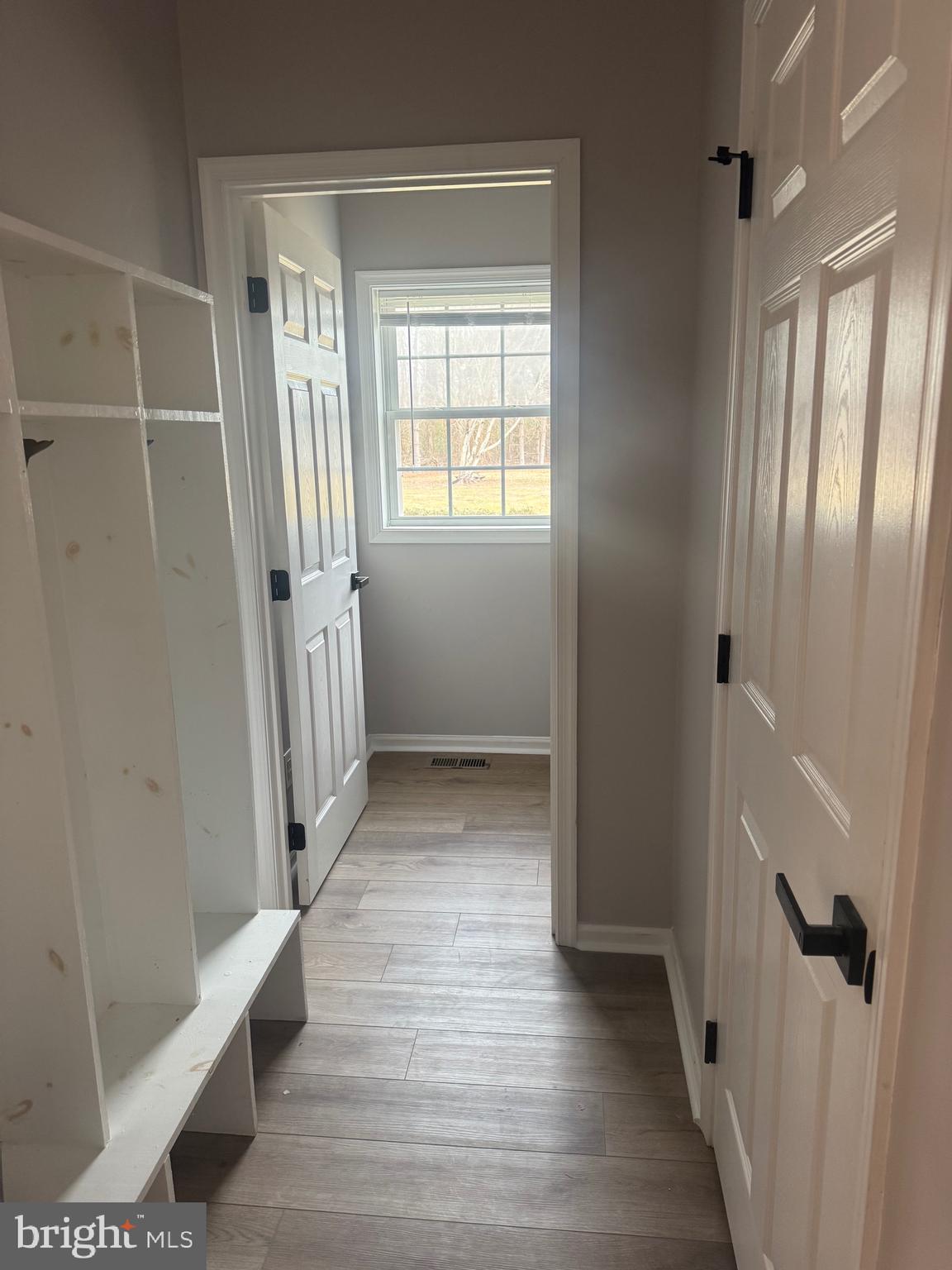 10342 Friendship Road Berlin, MD 21811 - Photo 16 of 28 a view of an empty room with wooden floor and a window