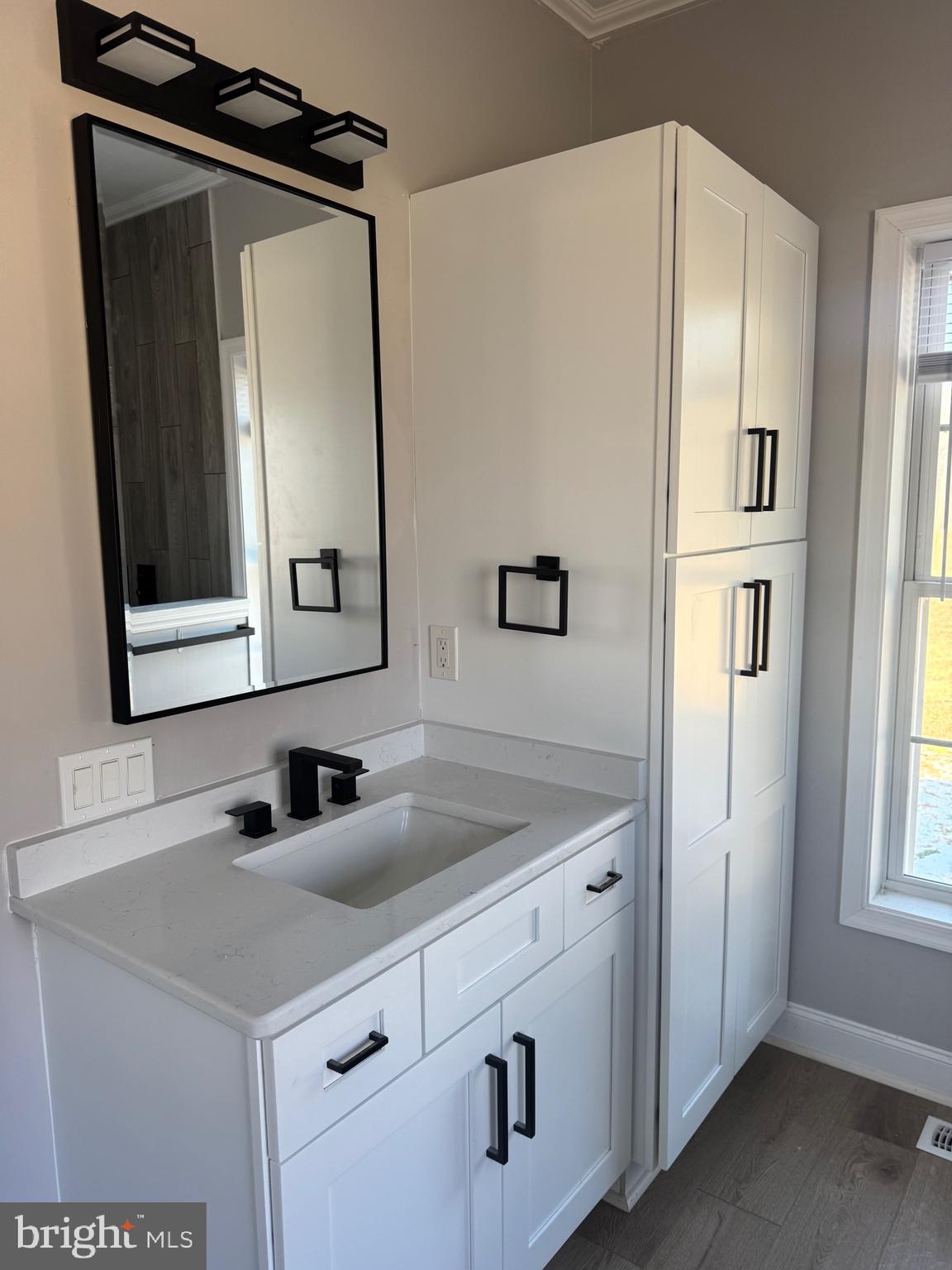 10342 Friendship Road Berlin, MD 21811 - Photo 20 of 35 a bathroom with a sink a mirror and vanity