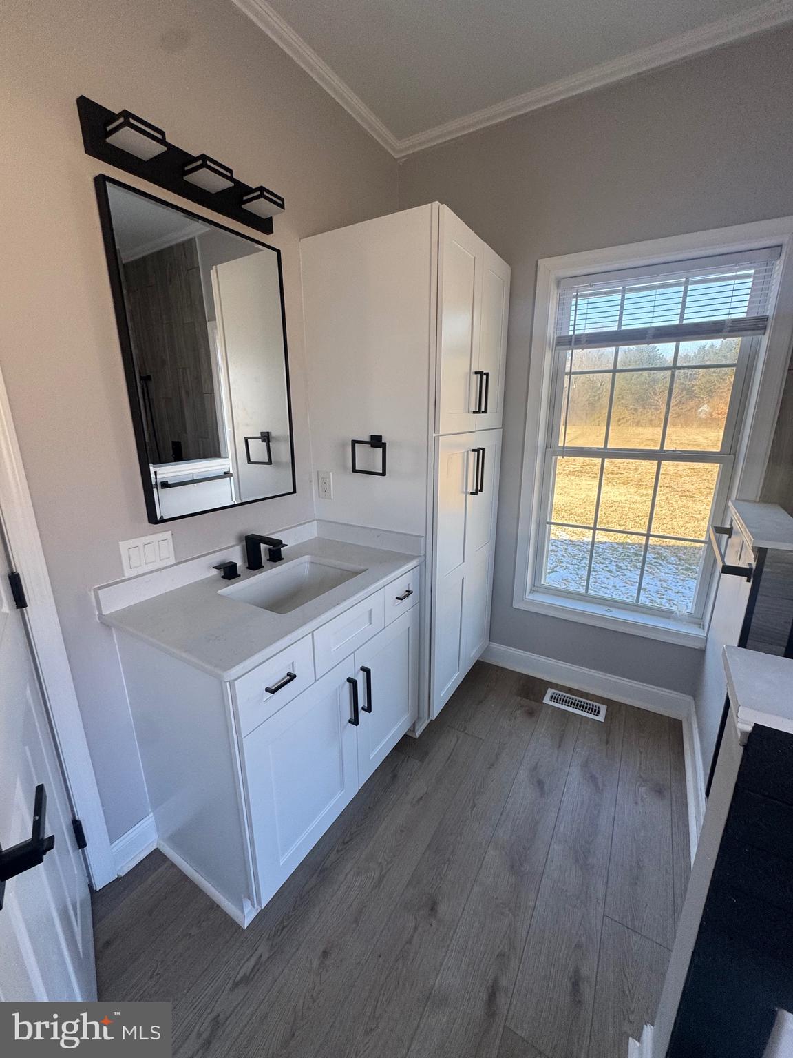 10342 Friendship Road Berlin, MD 21811 - Photo 25 of 28 a bathroom with a double vanity sink and mirror
