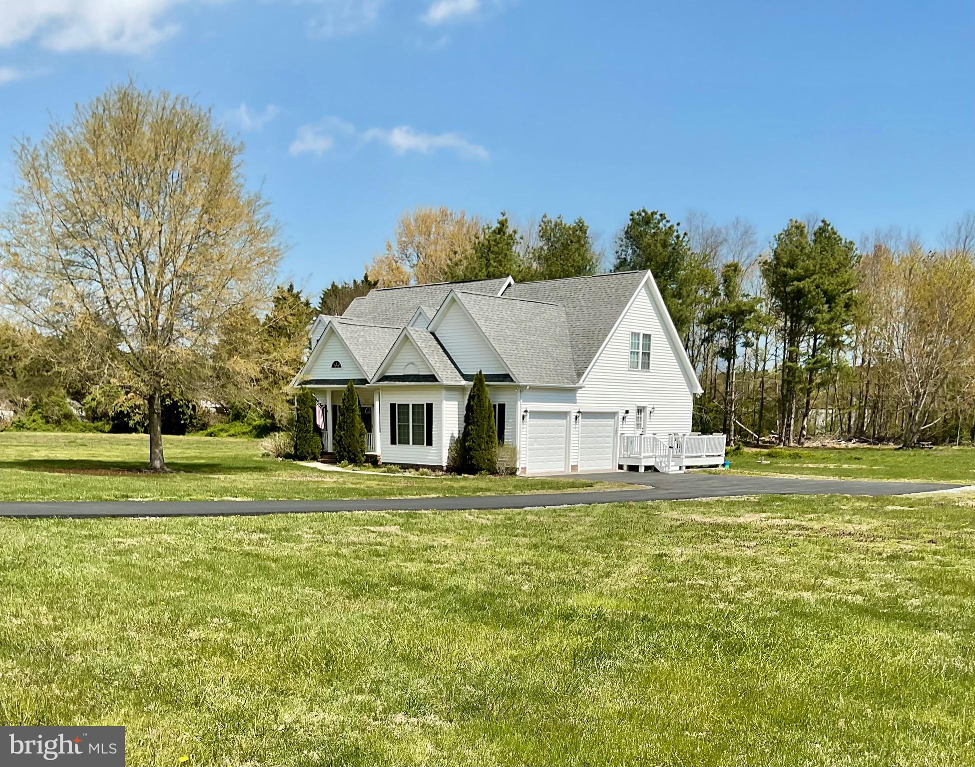 10342 Friendship Road Berlin, MD 21811 - Photo 29 of 35 a front view of a house with a garden and trees