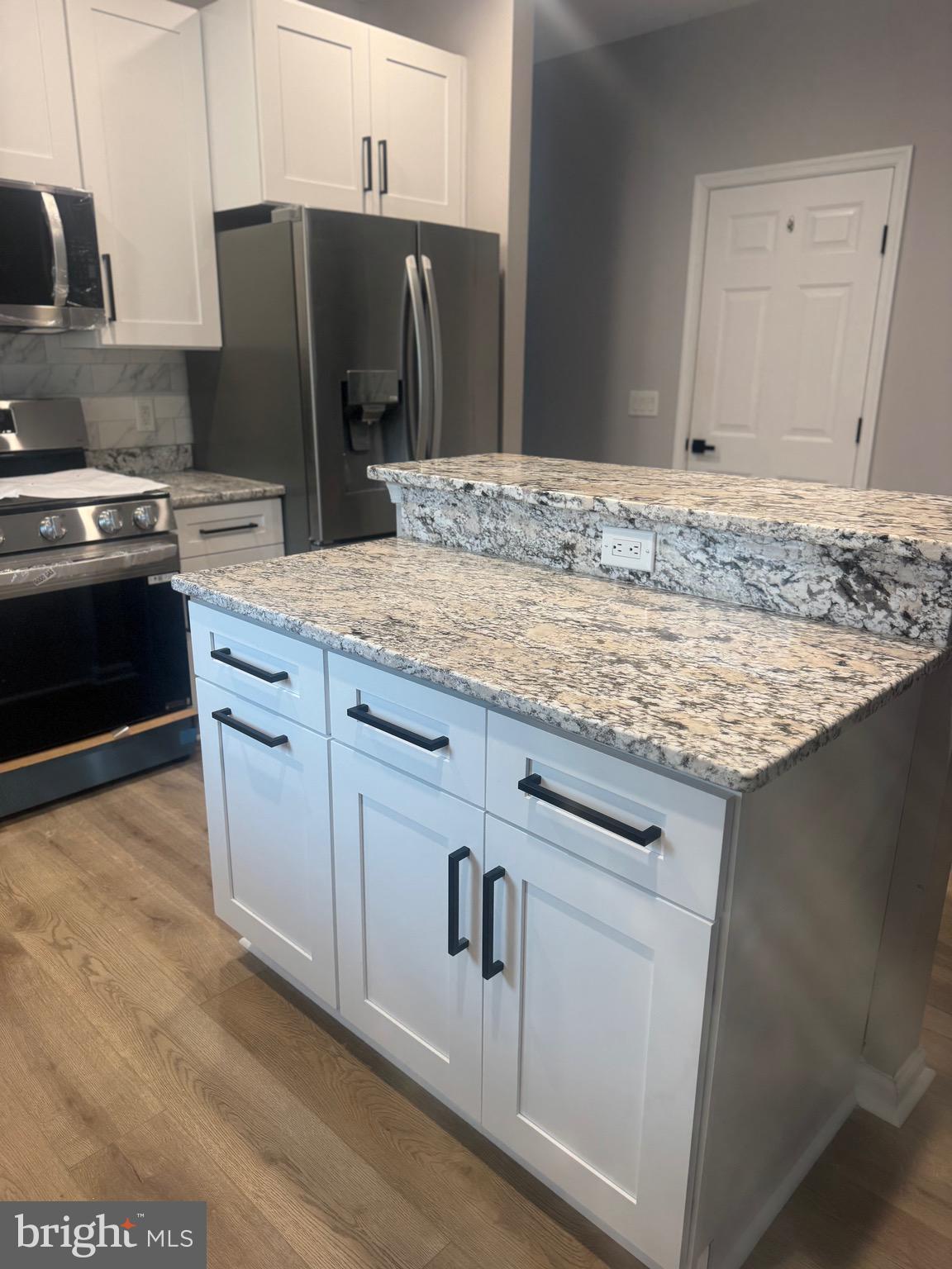 10342 Friendship Road Berlin, MD 21811 - Photo 10 of 28 a kitchen with stainless steel appliances granite countertop a sink stove and refrigerator