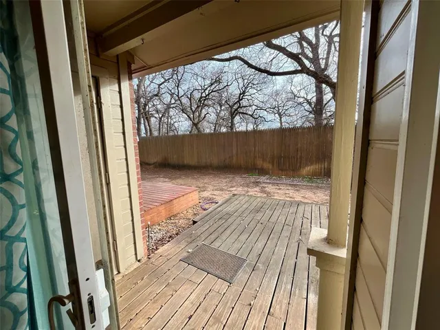 a view of wooden door and brick wall