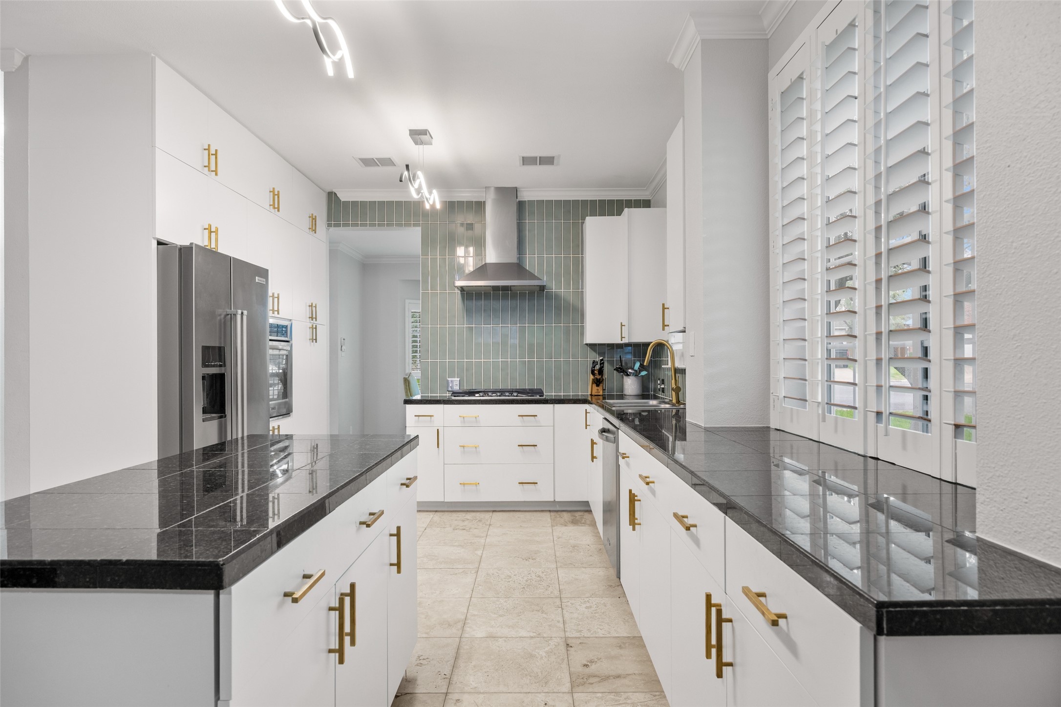 8610 Axis Drive Austin, TX 78749 - Photo 13 of 29 a large white kitchen with granite countertop a sink and stainless steel appliances