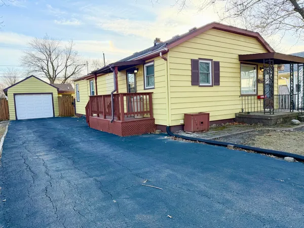 a view of backyard with a garden and deck
