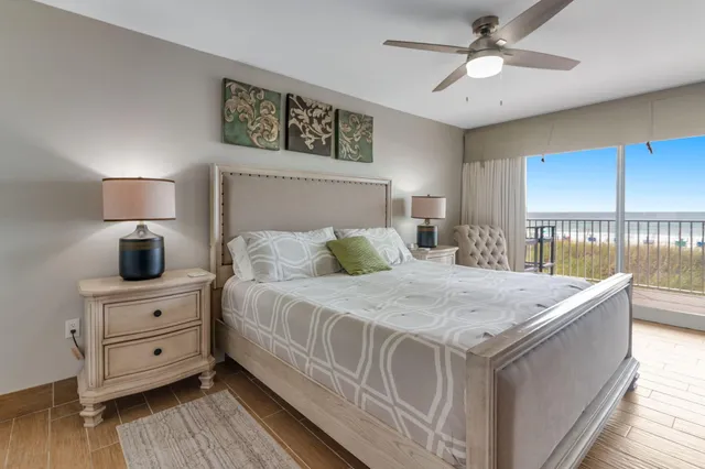 a bedroom with a bed and a lamp on dresser