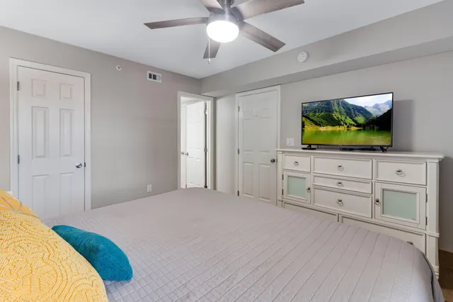 a bedroom with a bed and a flat screen tv