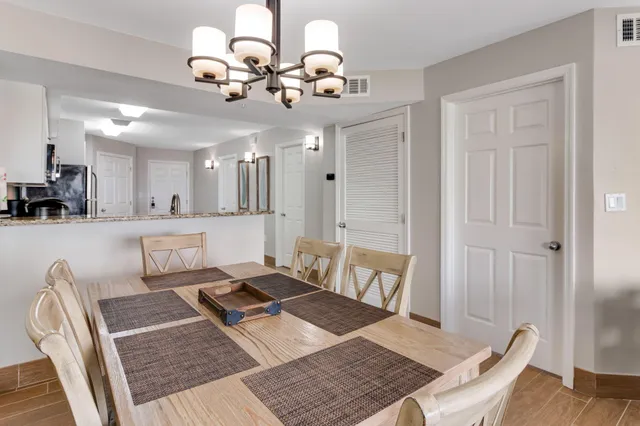a living room with a couch and chandelier