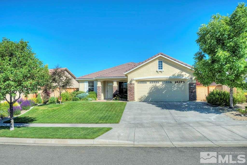 1100 Meridian Ranch Drive Reno, NV 89523 - Photo 1 of 25 a front view of a house with a yard and garage