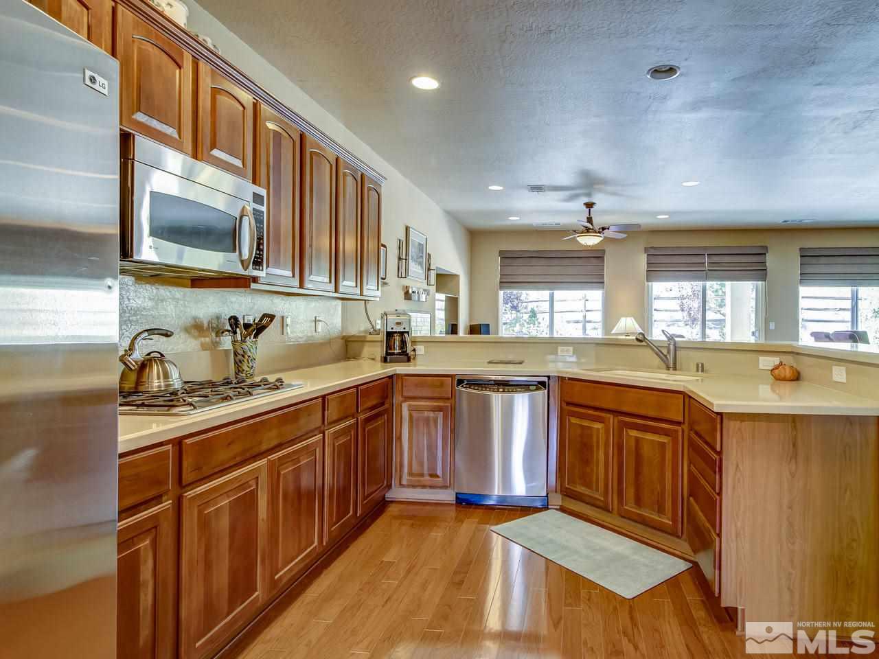 1100 Meridian Ranch Drive Reno, NV 89523 - Photo 11 of 25 a kitchen with stainless steel appliances granite countertop a sink stove and cabinets