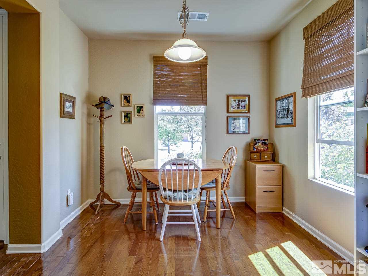1100 Meridian Ranch Drive Reno, NV 89523 - Photo 12 of 25 a dining room with furniture a chandelier and wooden floor