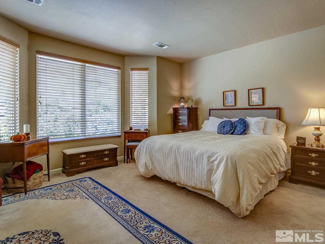 1100 Meridian Ranch Drive Reno, NV 89523 - Photo 14 of 25 a bedroom with a large bed and a large window