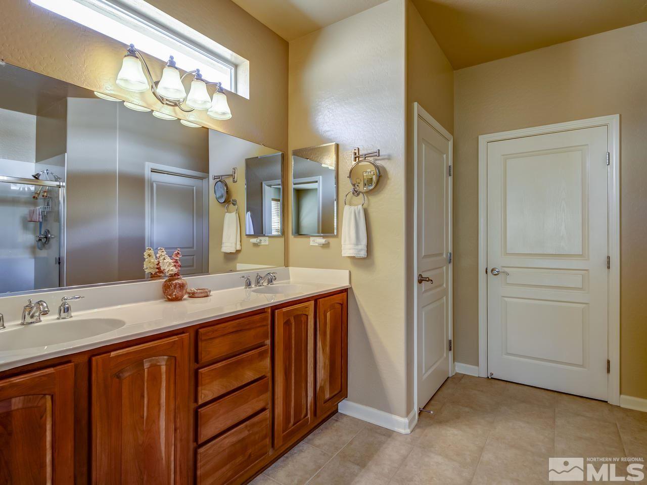 1100 Meridian Ranch Drive Reno, NV 89523 - Photo 18 of 25 a bathroom with a double vanity sink and a mirror