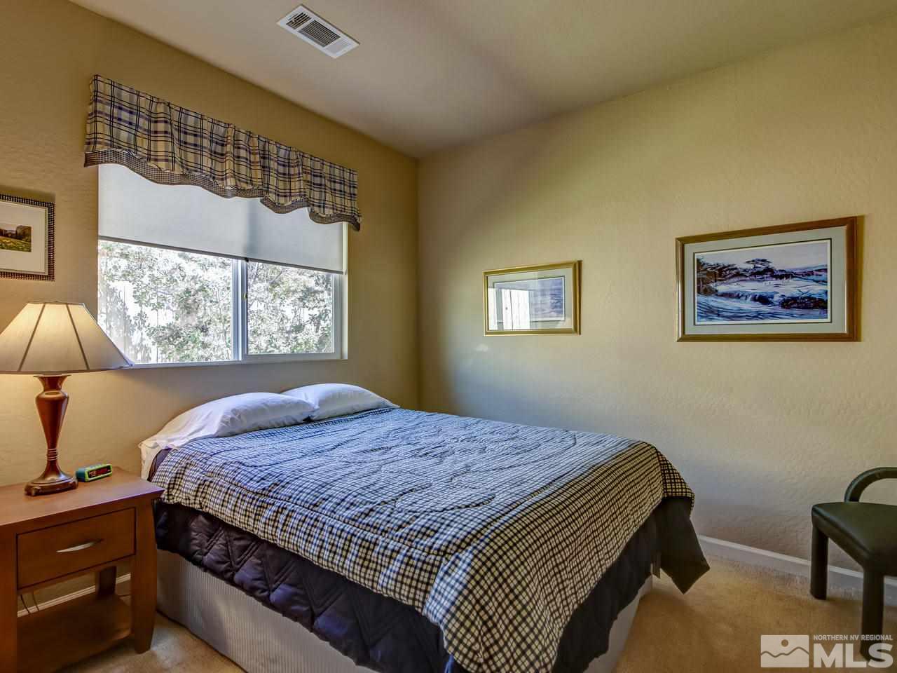 1100 Meridian Ranch Drive Reno, NV 89523 - Photo 19 of 25 a bedroom with a bed and a window
