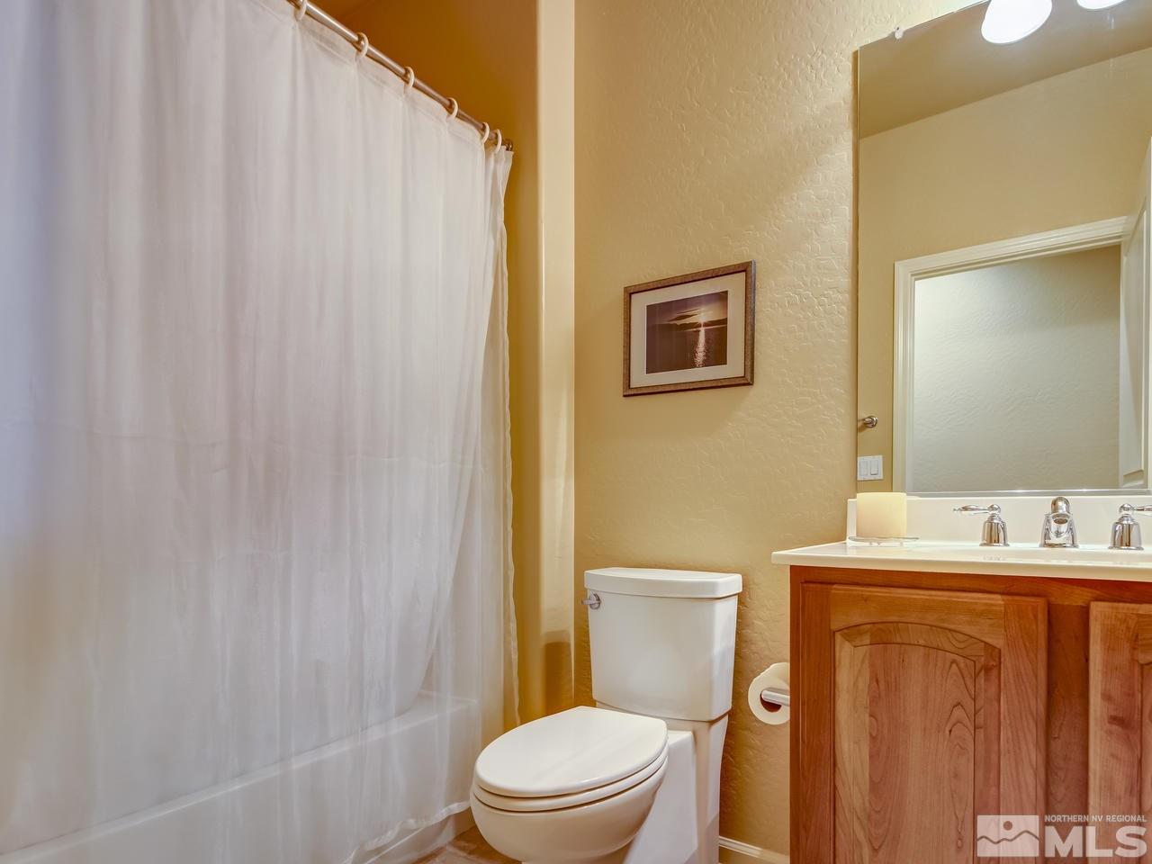 1100 Meridian Ranch Drive Reno, NV 89523 - Photo 21 of 25 a bathroom with a sink a toilet and a mirror