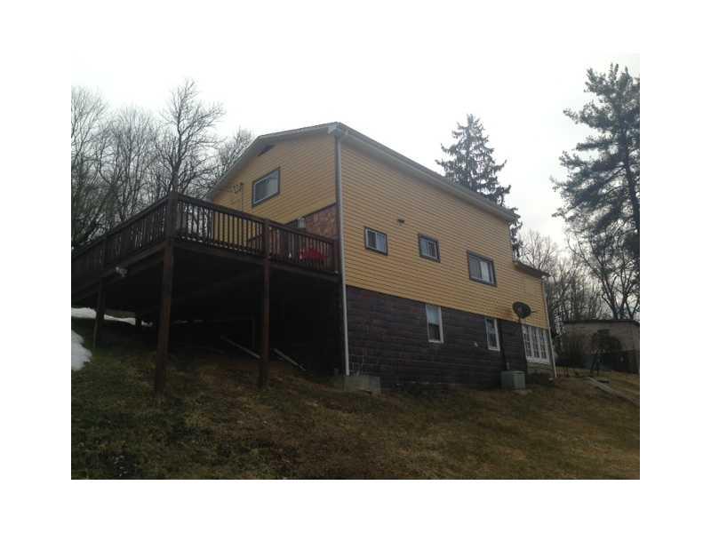 Exterior Back. Huge side deck for entertaining friends & family - full basement.