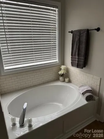 a bathroom with a bathtub and a window