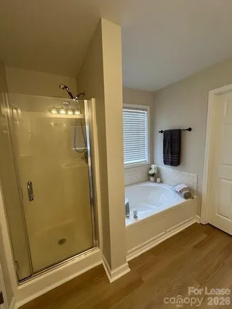 a bathroom with a tub and shower