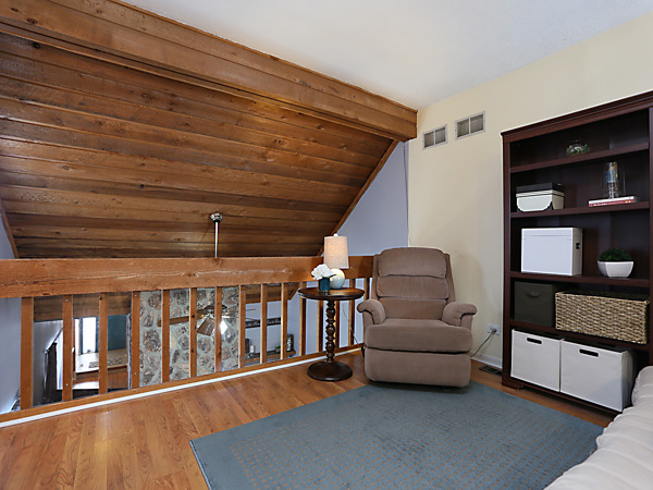 737 Shepard Court Gurnee, IL 60031 - Photo 17 of 18 a living room with furniture and a book shelf