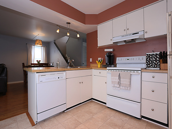 737 Shepard Court Gurnee, IL 60031 - Photo 5 of 18 a kitchen with white cabinets and white appliances