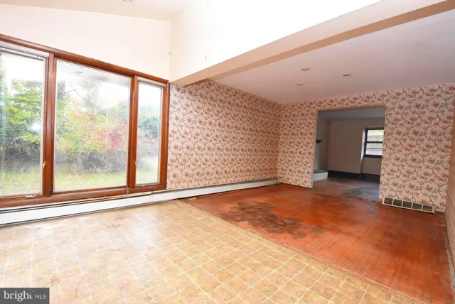 an empty room with large windows