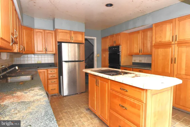 a kitchen with granite countertop cabinets and appliances