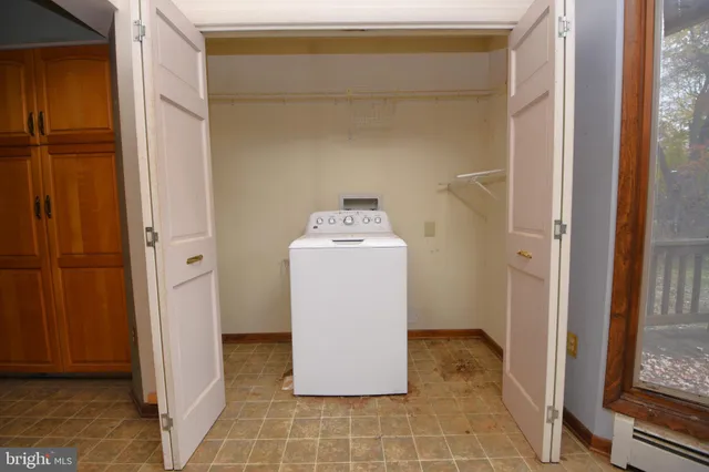 a view of an empty room with a fireplace