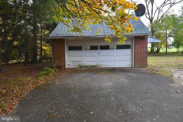 an aerial view of a house with a yard table and chairs