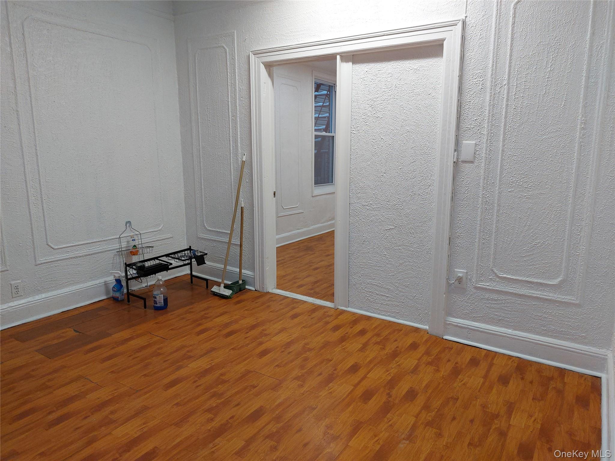 52-12 108th Street Queens, NY 11368 - Photo 2 of 8 a room with a wooden floor and a table