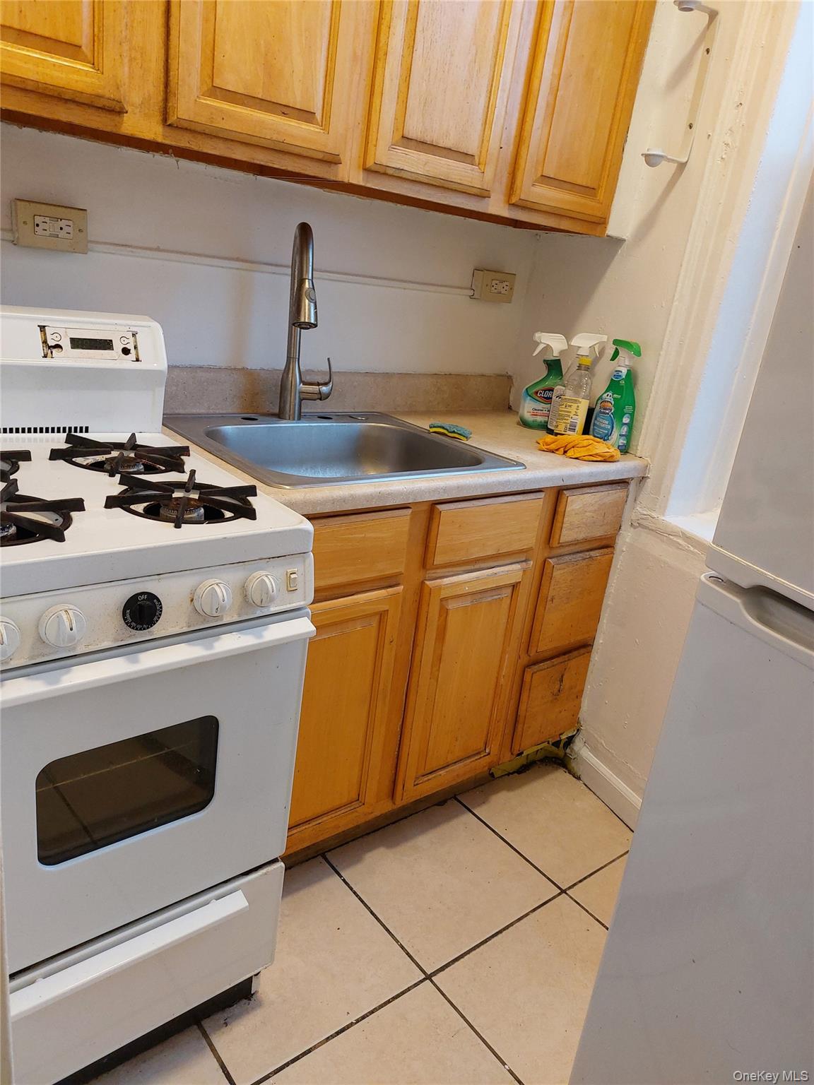 52-12 108th Street Queens, NY 11368 - Photo 3 of 8 a white stove top oven sitting inside of a kitchen