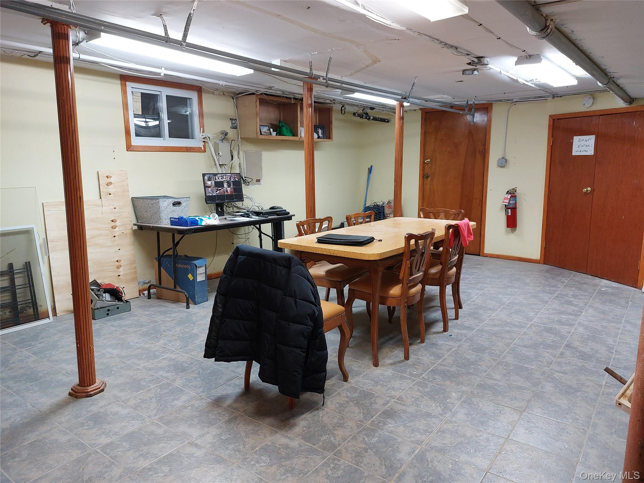 52-12 108th Street Queens, NY 11368 - Photo 4 of 8 a dining room with a wooden table and chairs