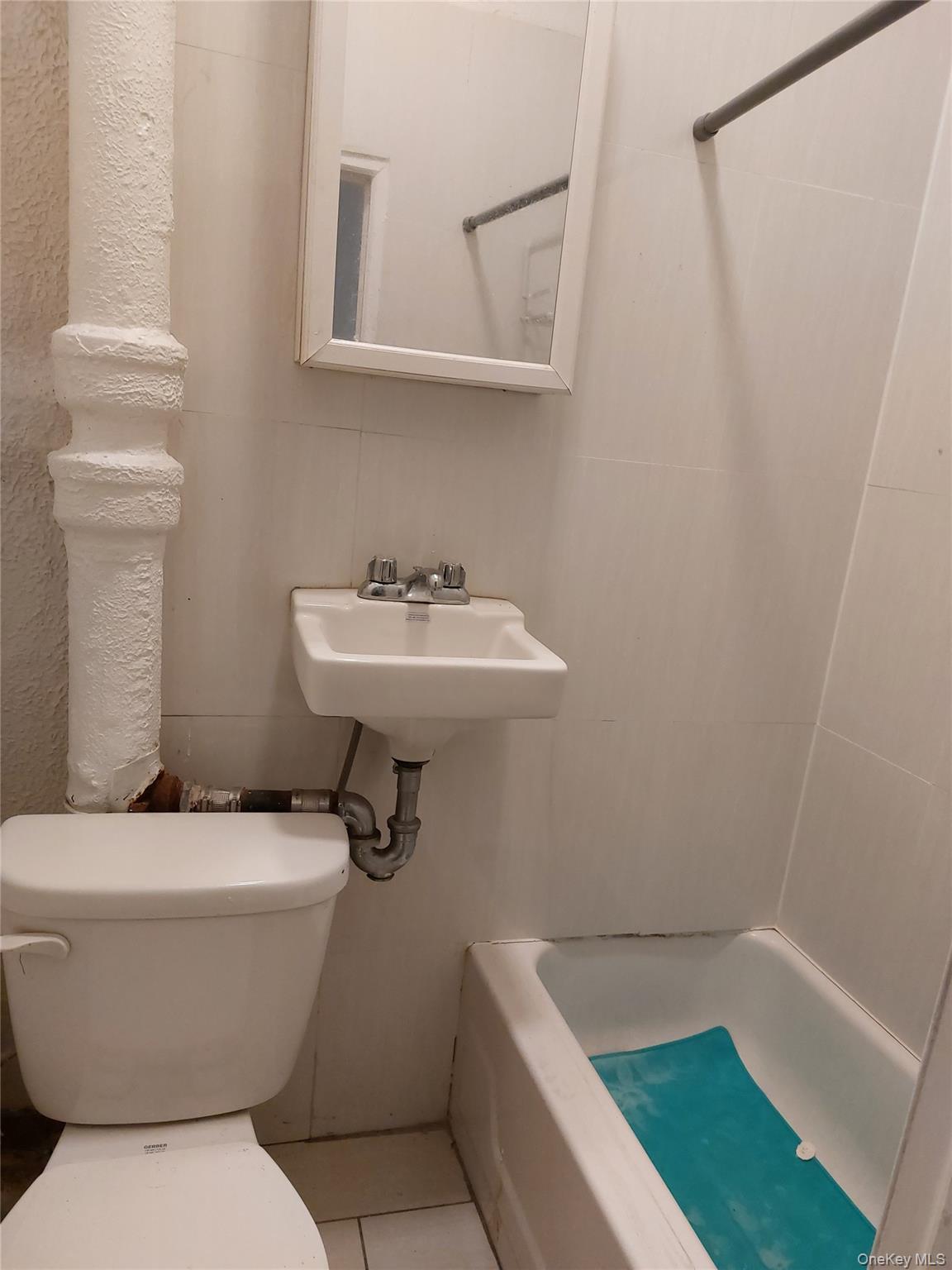 52-12 108th Street Queens, NY 11368 - Photo 5 of 8 a bathroom with a sink and mirror