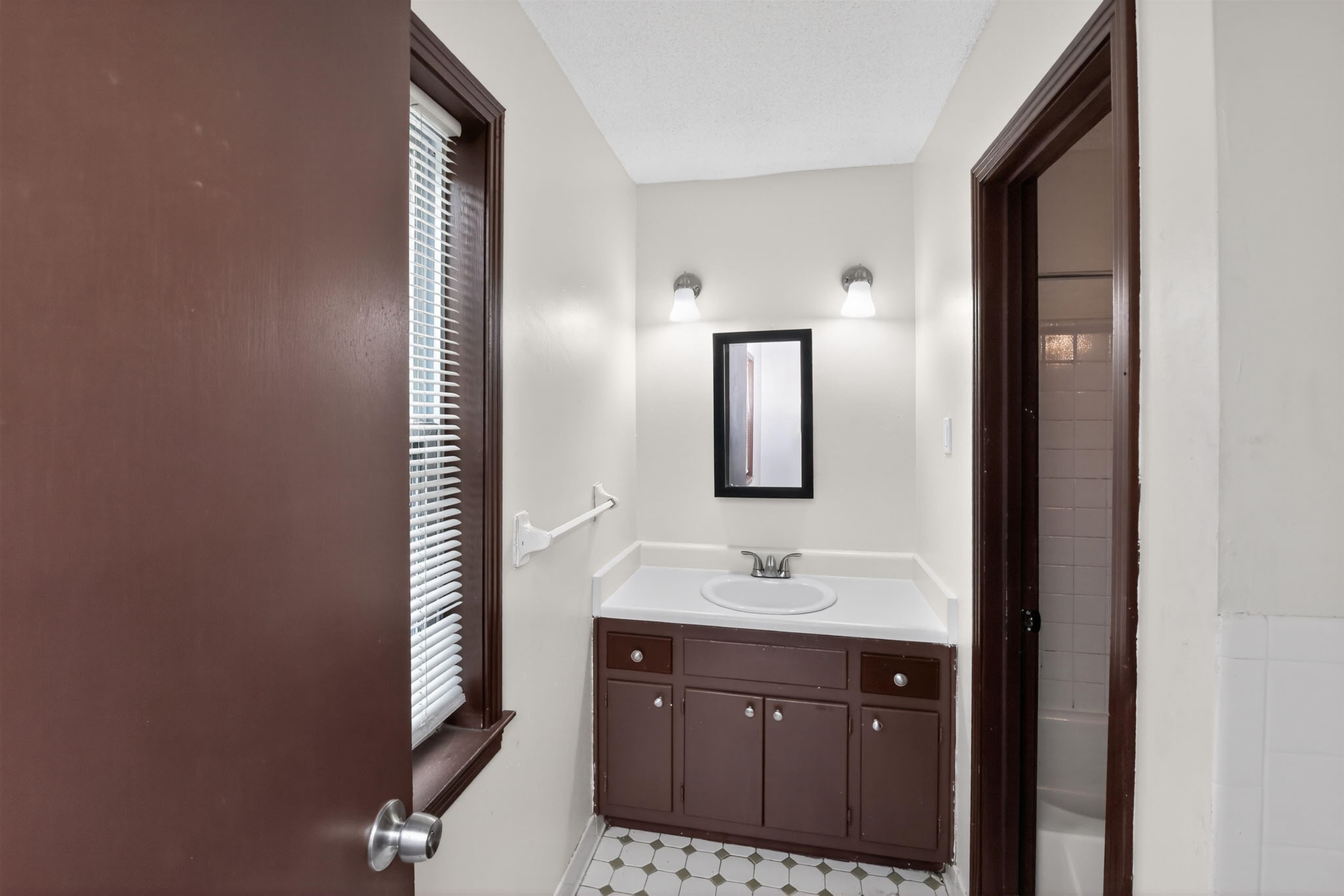 4206 Riche Road Memphis, TN 38128 - Photo 29 of 30 Bathroom featuring a brown vanity with a white countertop and integrated sink