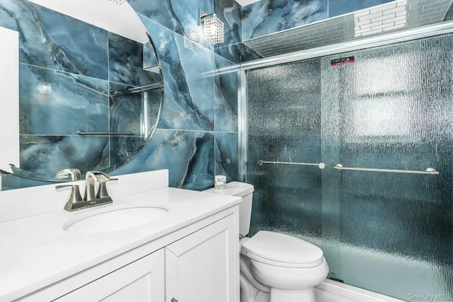 a bathroom with a sink toilet and shower