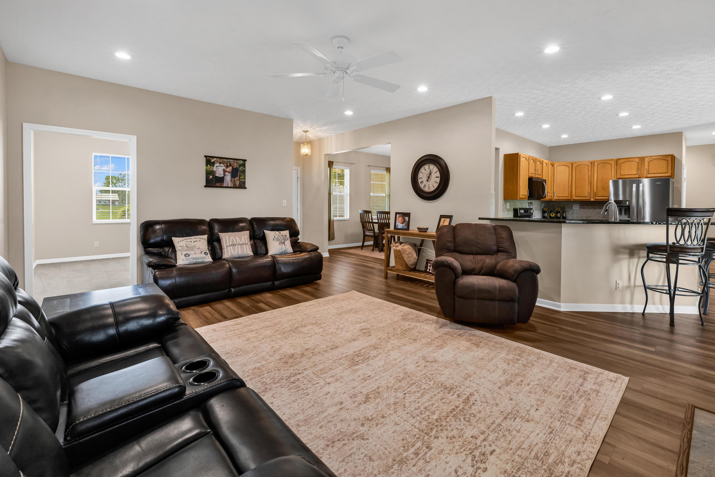 14396 Blamer Road Johnstown, OH 43031 - Photo 11 of 48 • New luxury vinyl plank
flooring ~ 2026
• Tan painted walls
• Can lighting
• Ceiling fan
• Stacked, stone fireplace
with mantle & woodburning
stove insert
• 2” blinds