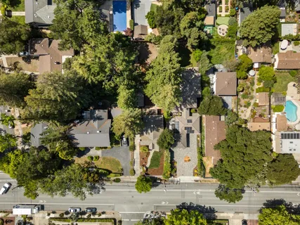 an aerial view of residential houses with city view