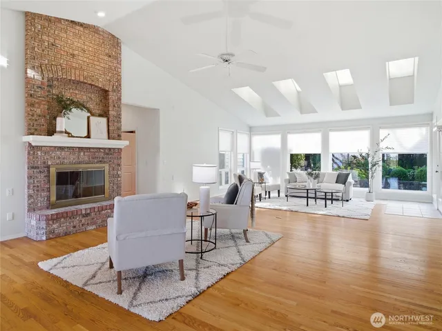 a living room with furniture large window and a fireplace
