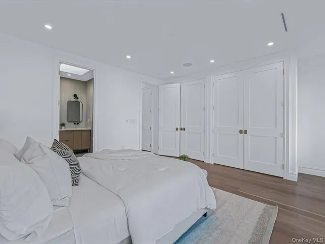 a bedroom with a bed and a mirror