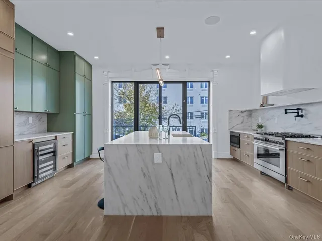 a living room with stainless steel appliances granite countertop furniture and a wooden floor