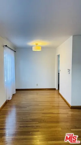 a view of an empty room and wooden floor