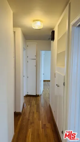 a view of hallway with wooden floor